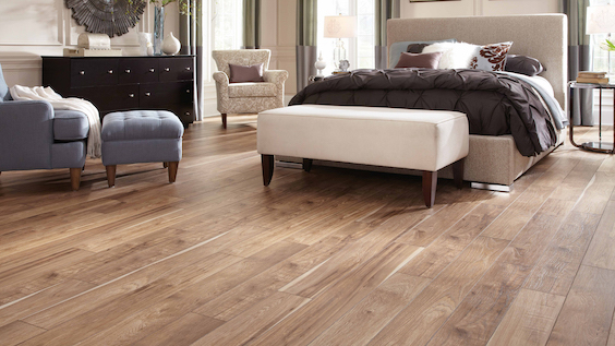wide plank wood look laminate flooring in a bedroom